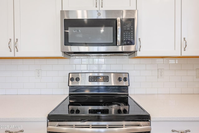 7648 W Kerby Ave, Phoenix, AZ 85043 - kitchen with appliances with stainless steel finishes, white cabinets, and backsplash