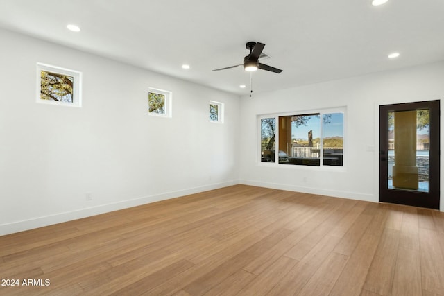 unfurnished room with light hardwood / wood-style flooring and ceiling fan