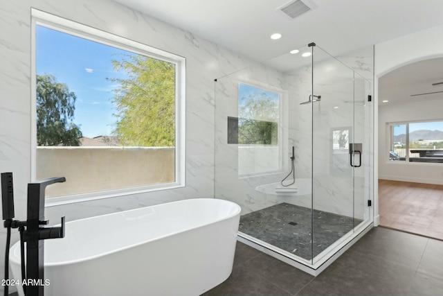 bathroom with tile patterned floors and independent shower and bath