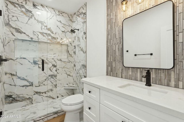 bathroom with vanity, an enclosed shower, and toilet