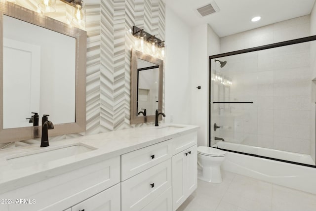 full bathroom with tile patterned floors, vanity, enclosed tub / shower combo, and toilet