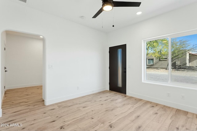 spare room featuring light wood-type flooring and ceiling fan