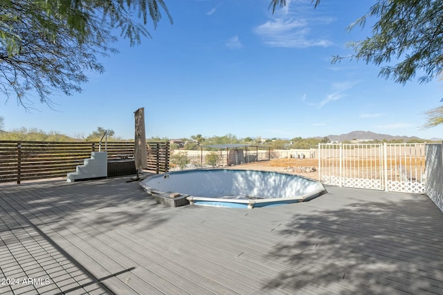 view of swimming pool featuring a deck with mountain view