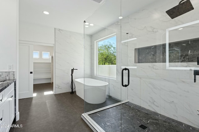 bathroom featuring vanity and separate shower and tub