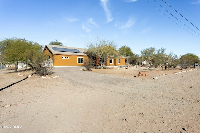 view of front of property featuring solar panels