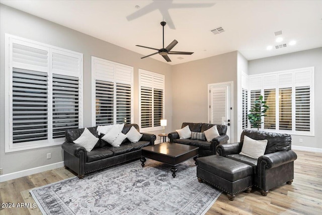 living room with ceiling fan and light hardwood / wood-style flooring