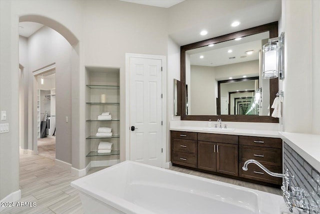 bathroom featuring a bathtub, vanity, and hardwood / wood-style flooring