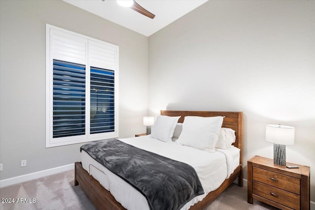 carpeted bedroom featuring ceiling fan and vaulted ceiling