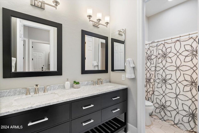 bathroom featuring tile patterned flooring, vanity, and toilet