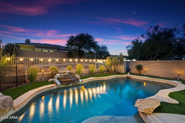 view of pool at dusk