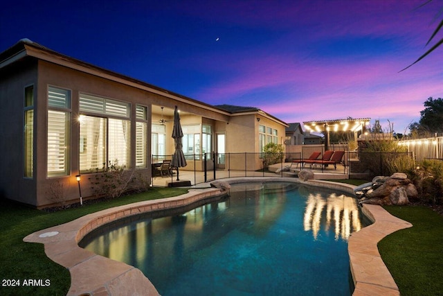 pool at dusk with a patio