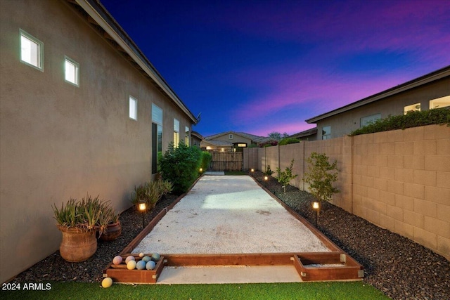 yard at dusk with a patio area