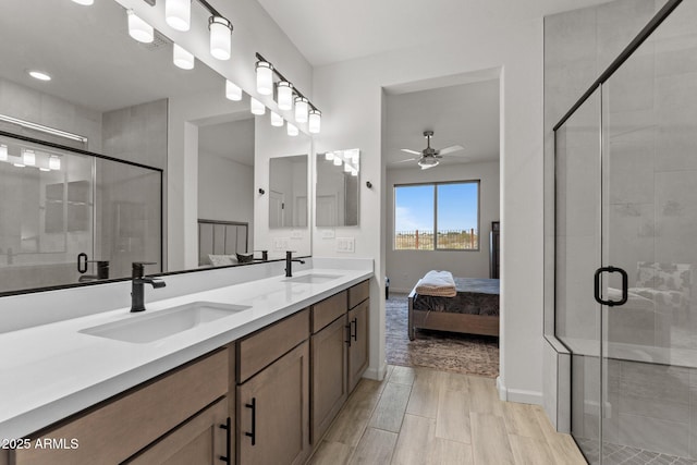 bathroom featuring vanity, ceiling fan, and a shower with shower door