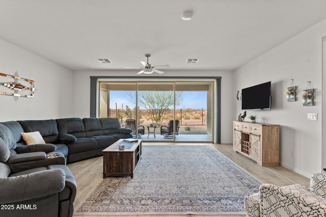 living room with light hardwood / wood-style flooring and ceiling fan