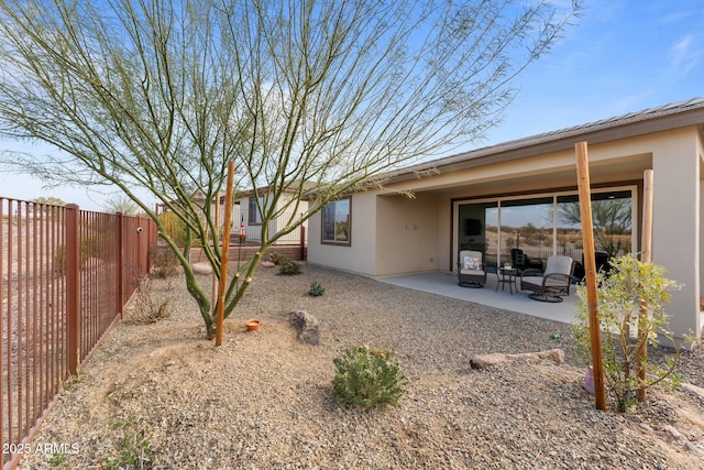 rear view of property featuring a patio area