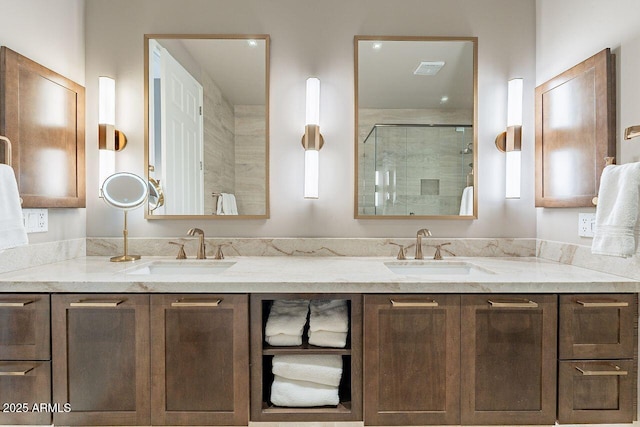 full bathroom with double vanity, a sink, and a shower stall