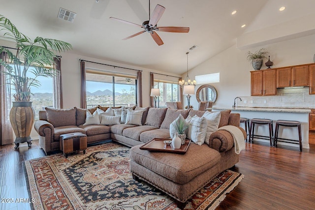 living room featuring high vaulted ceiling, visible vents, and dark wood finished floors