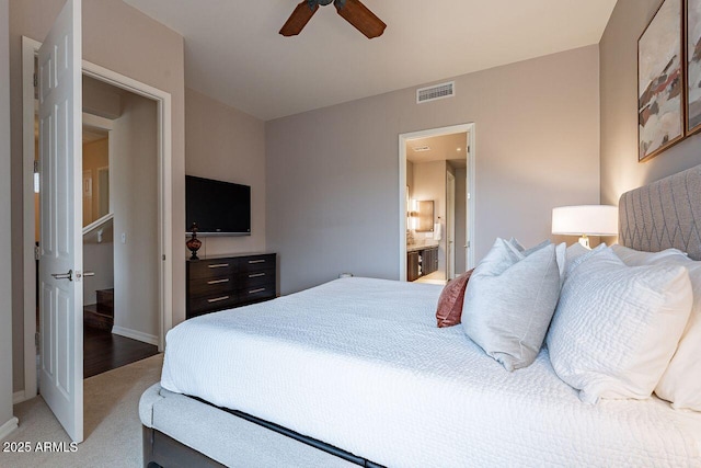 bedroom featuring light carpet, baseboards, visible vents, connected bathroom, and ceiling fan