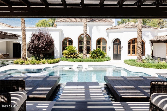 view of pool with a pergola, a patio area, and an in ground hot tub