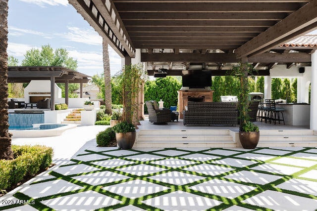 view of terrace featuring an outdoor kitchen, a pergola, a bar, an outdoor living space, and a swimming pool side deck