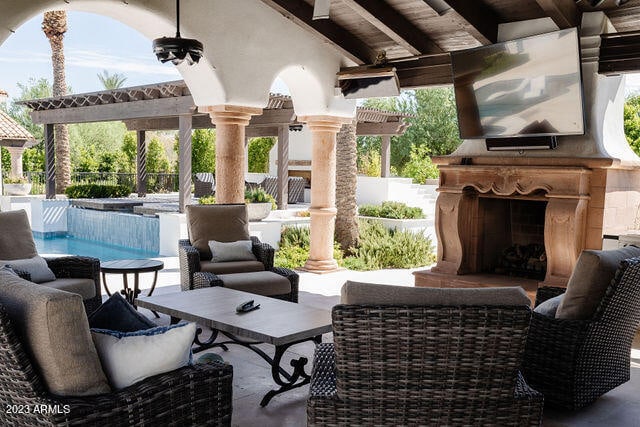 view of terrace featuring an outdoor living space with a fireplace
