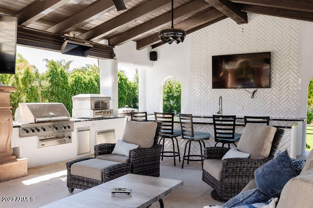 view of patio featuring an outdoor hangout area, an outdoor kitchen, and a grill