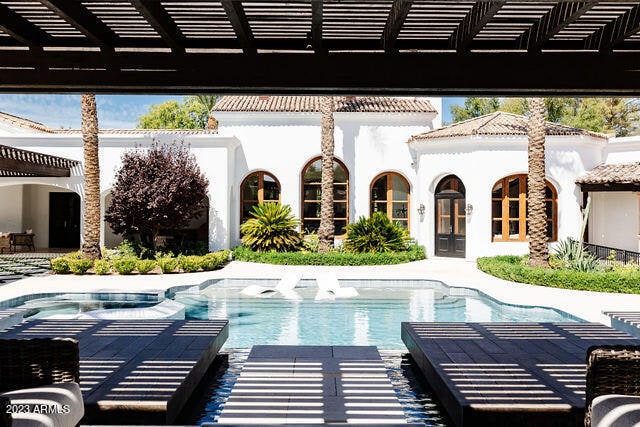view of pool featuring a patio, a pergola, and a hot tub