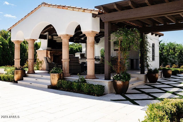 exterior space with an outdoor fireplace
