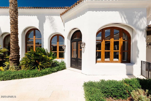 view of exterior entry featuring french doors
