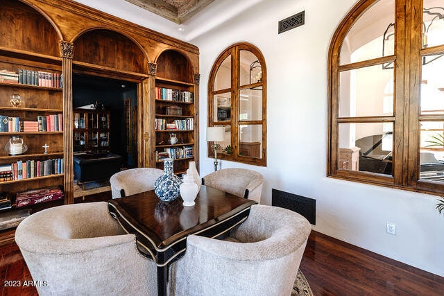 sitting room featuring dark hardwood / wood-style flooring and built in shelves