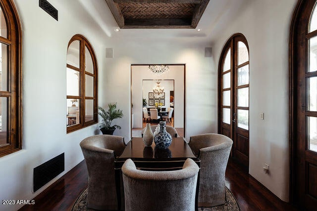 dining space featuring a tray ceiling, french doors, and dark hardwood / wood-style flooring