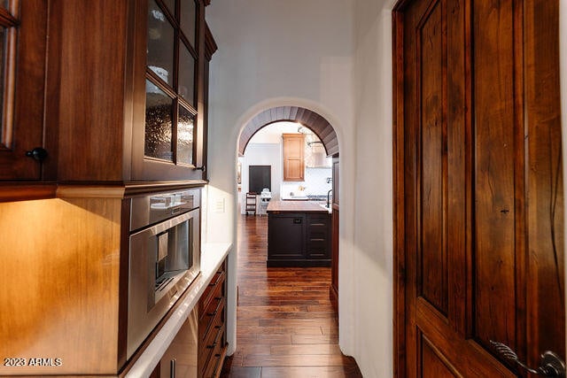 kitchen featuring dark brown cabinets and dark hardwood / wood-style floors