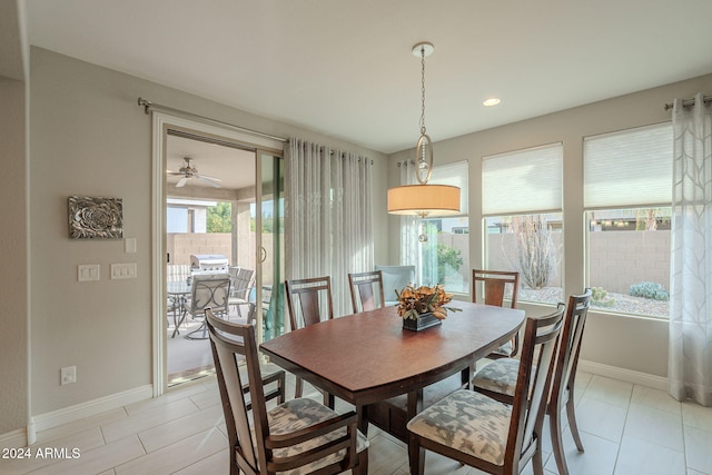 tiled dining area featuring ceiling fan