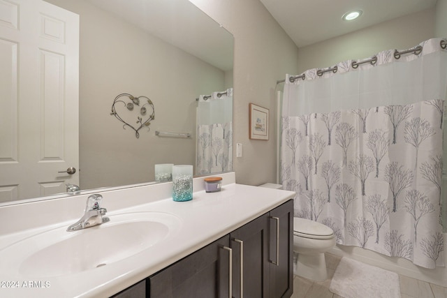 full bathroom featuring tile patterned flooring, shower / bath combination with curtain, vanity, and toilet