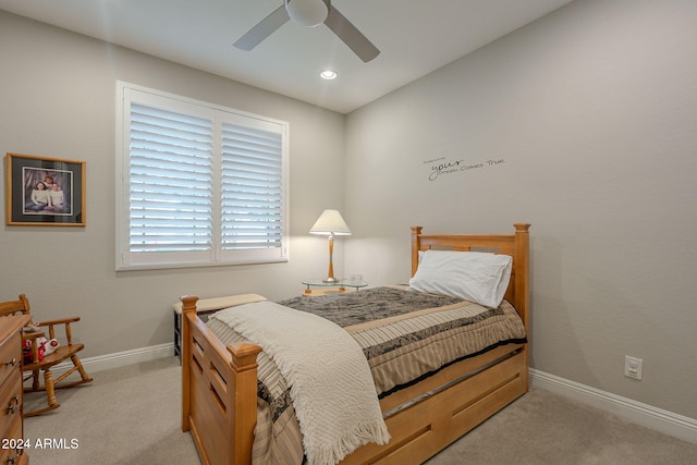 bedroom featuring ceiling fan and light carpet