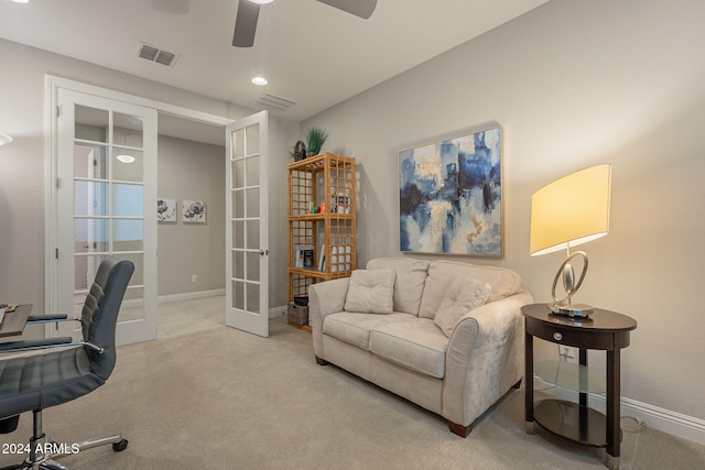 carpeted home office with french doors and ceiling fan