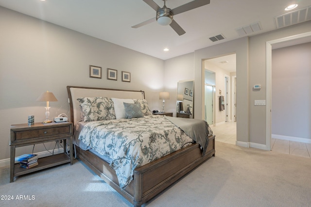 bedroom with ceiling fan and light colored carpet