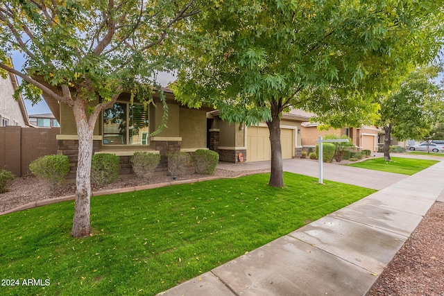 view of front of property with a front lawn and a garage