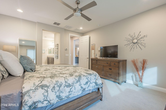 carpeted bedroom featuring ceiling fan and ensuite bath