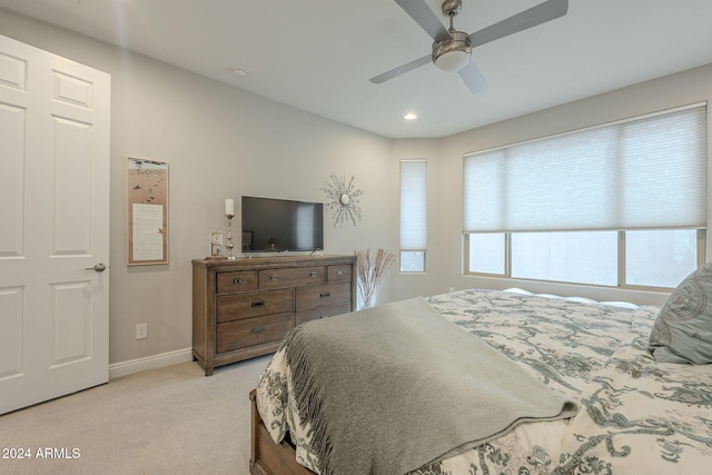 bedroom featuring ceiling fan and light carpet