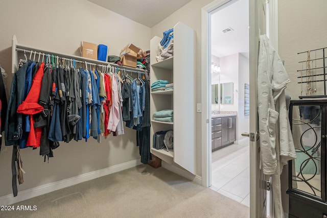 walk in closet featuring carpet flooring