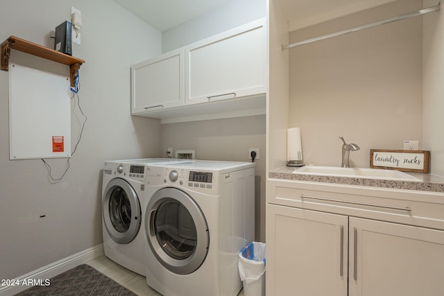 laundry room with sink, light tile patterned floors, cabinets, and independent washer and dryer