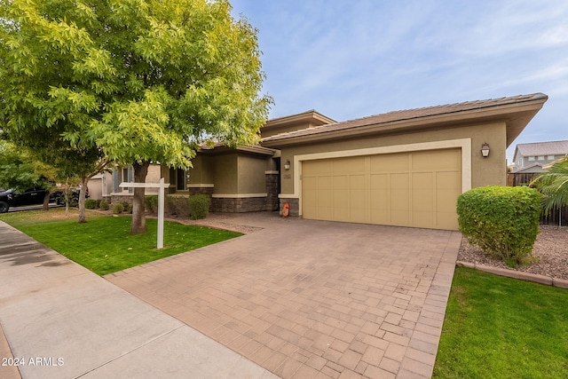 view of front of home featuring a garage and a front lawn