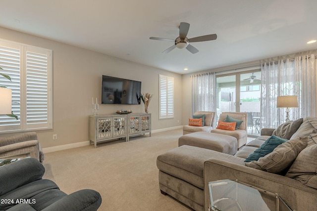 living room with light colored carpet and ceiling fan