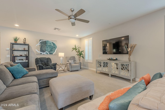 carpeted living room with ceiling fan