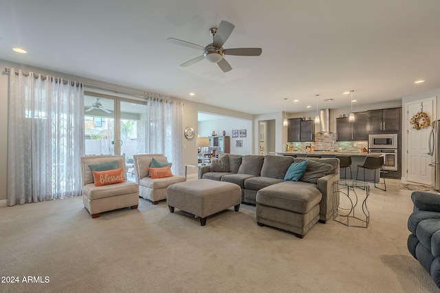 carpeted living room featuring ceiling fan