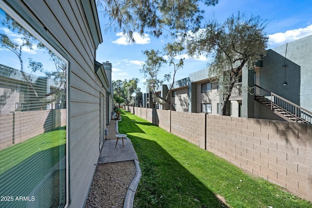 view of yard featuring a residential view, a patio area, and a fenced backyard