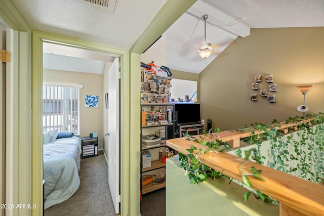 carpeted bedroom with vaulted ceiling, a textured ceiling, and visible vents