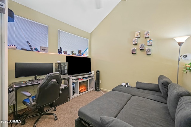 carpeted office space featuring vaulted ceiling