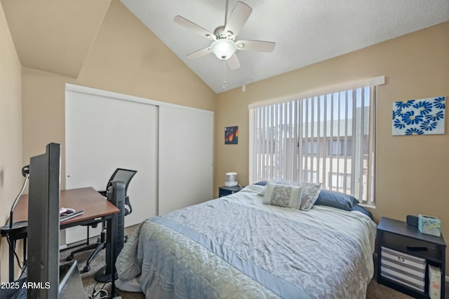 carpeted bedroom featuring vaulted ceiling, ceiling fan, and a closet